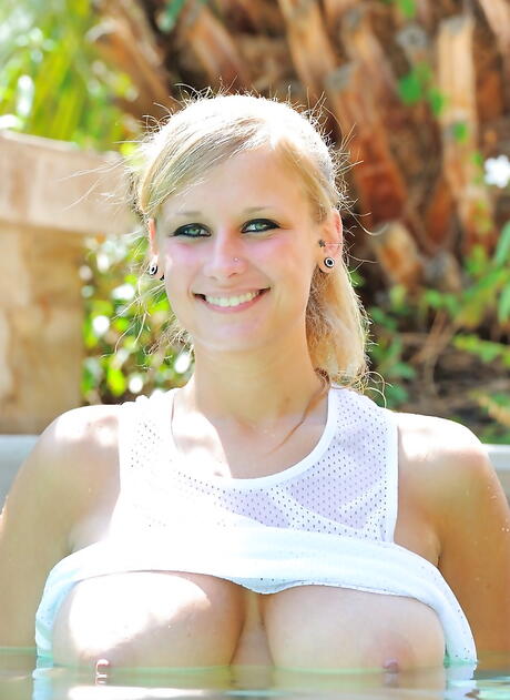 Enchanting american blond hottie Alice Wonder in panties exhibiting big tits and spreading her legs near the pool